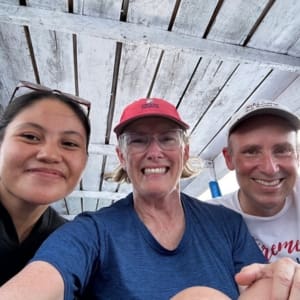3 people in a boat in raja ampat indonesia