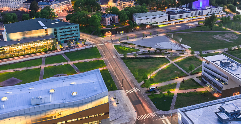 Large modern building and green area in Central Helsinki housing Library Oodi