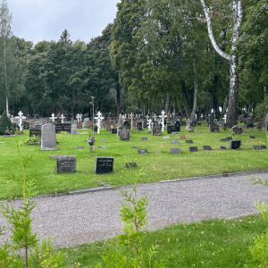 Gravesites in green grassy area at National Cemetery in Finland