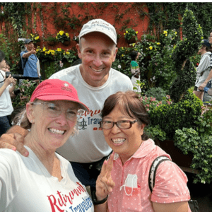 John and Bev standing with a woman in the Cloud Forest of Singapore