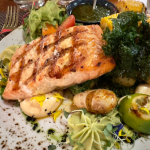 dinner plate with salmon filet and vegetables