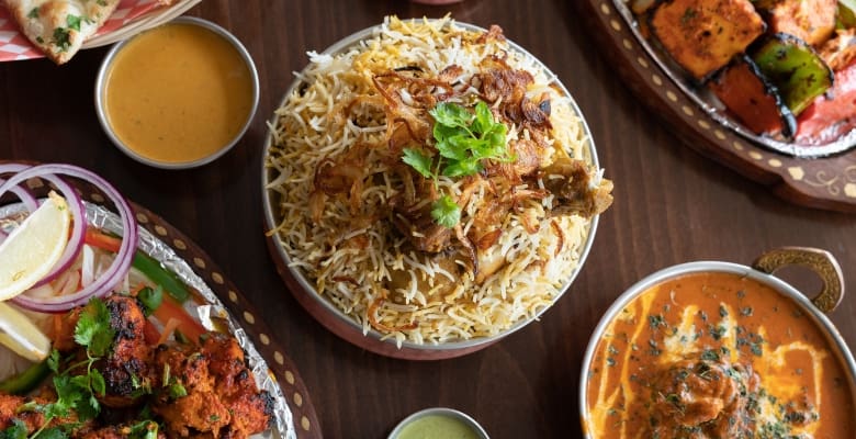 A variety of Indian foods in bowls on a table