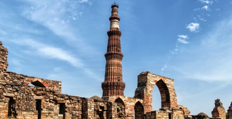 Tall brick circular tower surrounded by arched brick walls