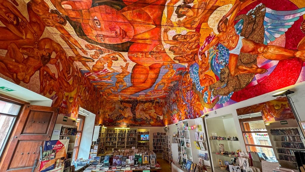 the bookstore at Biblioteca Publica which is a colorful mural on the ceiling.