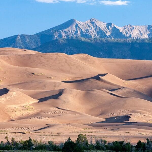 sand dunes and snow capped mountains in colorado