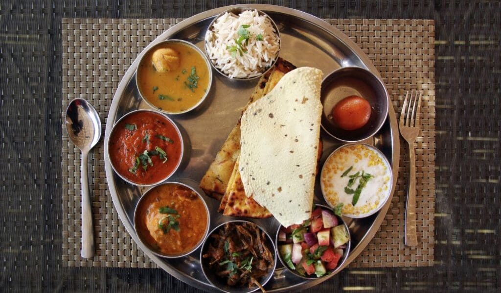 a variety of indian foods on tray